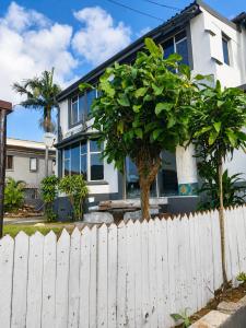 a white fence in front of a white house at 42 On Canterbury in Durban