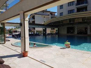 two people in a swimming pool in a building at Sun Sea 2 in Shkorpilovtsi
