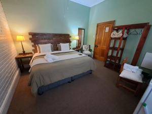 a bedroom with a large bed and a mirror at Selborne Bed and Breakfast in East London