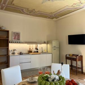 a kitchen with a table with a bowl of fruit on it at SAGGEZZA Villa di GARGNANO in Gargnano