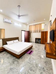 a bedroom with a bed and a flat screen tv at Takery Resort in Chittaurgarh