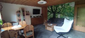 a living room with a table and a couch at Sonnenhaus Leo Hutthurm in Hutthurm