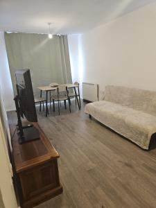 a living room with a couch and a table at 2bdr Ground Floor Flat in Edmonton free Parking and WiFi in Ponders End