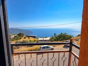 a balcony with a view of the ocean at Alınca Elm Pansiyon in Fethiye
