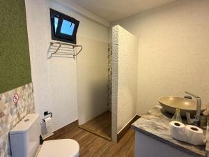 a bathroom with a white toilet and a sink at Alınca Elm Pansiyon in Fethiye
