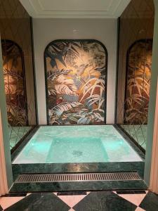 a swimming pool in a room with a painting on the wall at Classyc Hotel Hang Buom in Hanoi