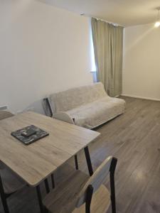 a living room with a table and a couch at 2bdr Ground Floor Flat in Edmonton free Parking and WiFi in Ponders End
