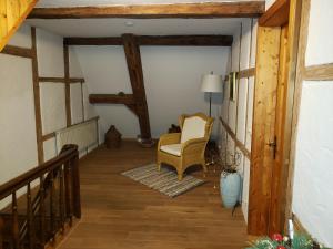 a hallway with a chair and a lamp in a house at Ferienhaus Herzogenreuth in Heiligenstadt