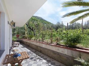 a patio with a table and a view of a garden at Ara Solis in Arola