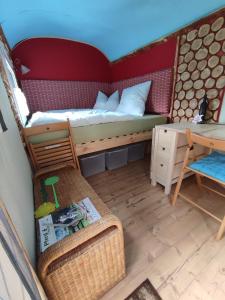 a small room with a bed and a desk at LandAuszeit Hummeltal in Culm +6 photos