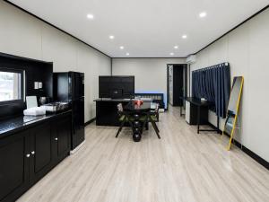 a room with a desk and a table in it at The Luxe Homestay in Buôn Ðũng