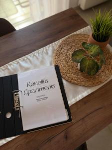 a book on a table next to a basket and a plant at Kanelli΄s apartments in Monemvasia