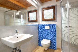 a bathroom with a sink and a toilet and a shower at AchKaszuby domki nad morzem in Puck +71 photos