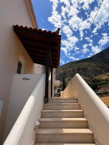 a set of stairs leading up to a house with mountains in the background at Kanelli΄s apartments in Monemvasia