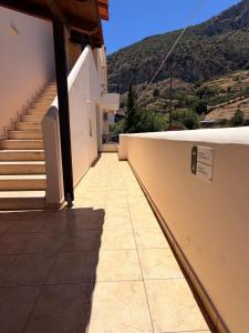 a hallway of a building with stairs and a mountain at Kanelli΄s apartments in Monemvasia