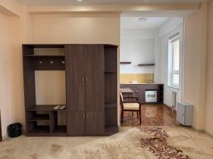 a large wooden cabinet in a room with a kitchen at Tsetsenkhangai Hotel in Ulaanbaatar