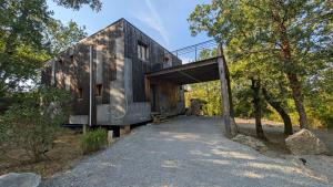 a house that is sitting in the woods at Villa Mammouth in Saint Alban Auriolles
