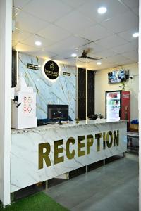 a reception desk with a reception sign on it at Hotel Jiio in Kurukshetra