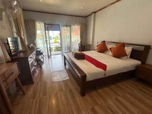 a bedroom with a bed and a television in it at Chaweng Bliss Bungalow in Chaweng