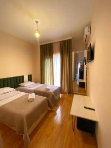 a hotel room with two beds and a table at მეშვე, MESHVE in Tsʼageri