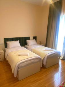 two beds sitting next to each other in a room at მეშვე, MESHVE in Tsʼageri