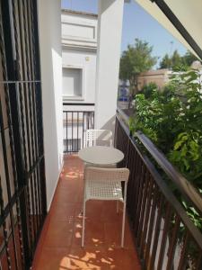 a table and two chairs on a balcony at Aires de Chipiona Apartamento A in Chipiona