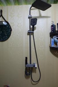 a blow dryer on a wall in a bathroom at The Bare Nest Retreat - Xóm Đung Homestay in Hòa Bình +6 photos