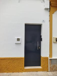 a black door on the side of a building at Aires de Chipiona Apartamento B in Chipiona