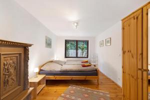 a bedroom with a bed and a fireplace at Urlaubsoase am Bruchsee in Templin