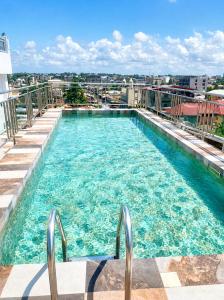 a large swimming pool on top of a building at Tchaopremium in Lomé
