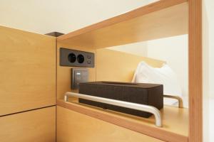 a toaster oven sitting on a shelf in a kitchen at Connected Hotel Nonhyeon in Seoul