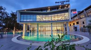 a large building with a pool in front of it at SSK Urmee in Cox's Bazar +15 photos