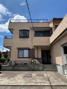 a large building with a staircase in front of it at はなれ香 in Kirishima