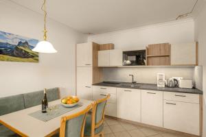 a kitchen with a table with a bowl of fruit on it at Residence Diana Apartment 102 in Terento