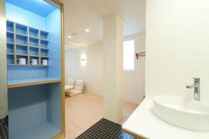 a bathroom with a white sink and a mirror at Connected Hotel Nonhyeon in Seoul +53 photos