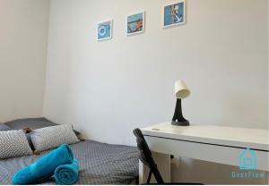 a bedroom with a desk with a bed and a lamp at Seaside Room in Gdynia