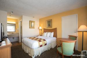 A bed or beds in a room at Budget Inn Sanford International Airport