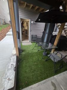 a patio with a table and chairs and an umbrella at beautiful private house in Edmonton
