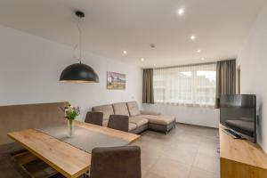 a living room with a table and a couch at Residence Diana Apartment 401 in Terento
