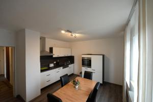 a kitchen with a wooden table and a dining room at Ferienwohnung Westfalenblick in Goldhausen