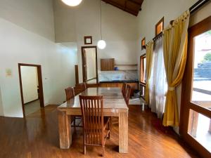 a dining room with a wooden table and chairs at Villa New IMS in Bandung