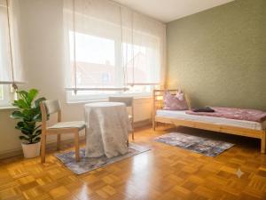 a room with a bed and a table and a window at Ein Zuhause auf Zeit in Osterburg