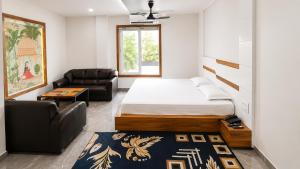 a bedroom with a bed and a couch and a chair at Jhankor Hotel in Sīkar