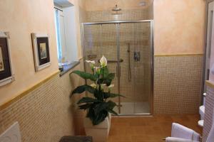 a bathroom with a shower with a plant in it at Le Logge Ritrovate in Acquasparta