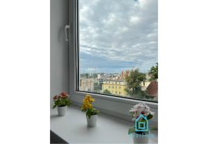 a window with a view of a city at Robot Room in Gdynia