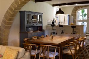 a dining room with a wooden table and chairs at Le Mas de Sòmi in Aubais