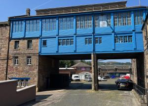 a blue building with a car parked under it at The Brewhouse Hotel in Edinburgh