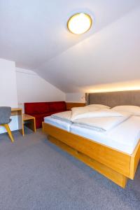 a bedroom with a bed and a desk at Haus Hubertus in Galtür
