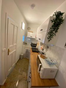 a kitchen with white cabinets and a counter top at Casa Tre Fiori 3 in Mignanego