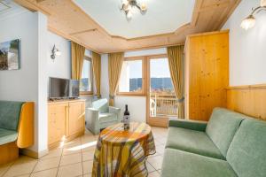 a living room with a couch and a table at Residence Diana Apartment 201 in Terento